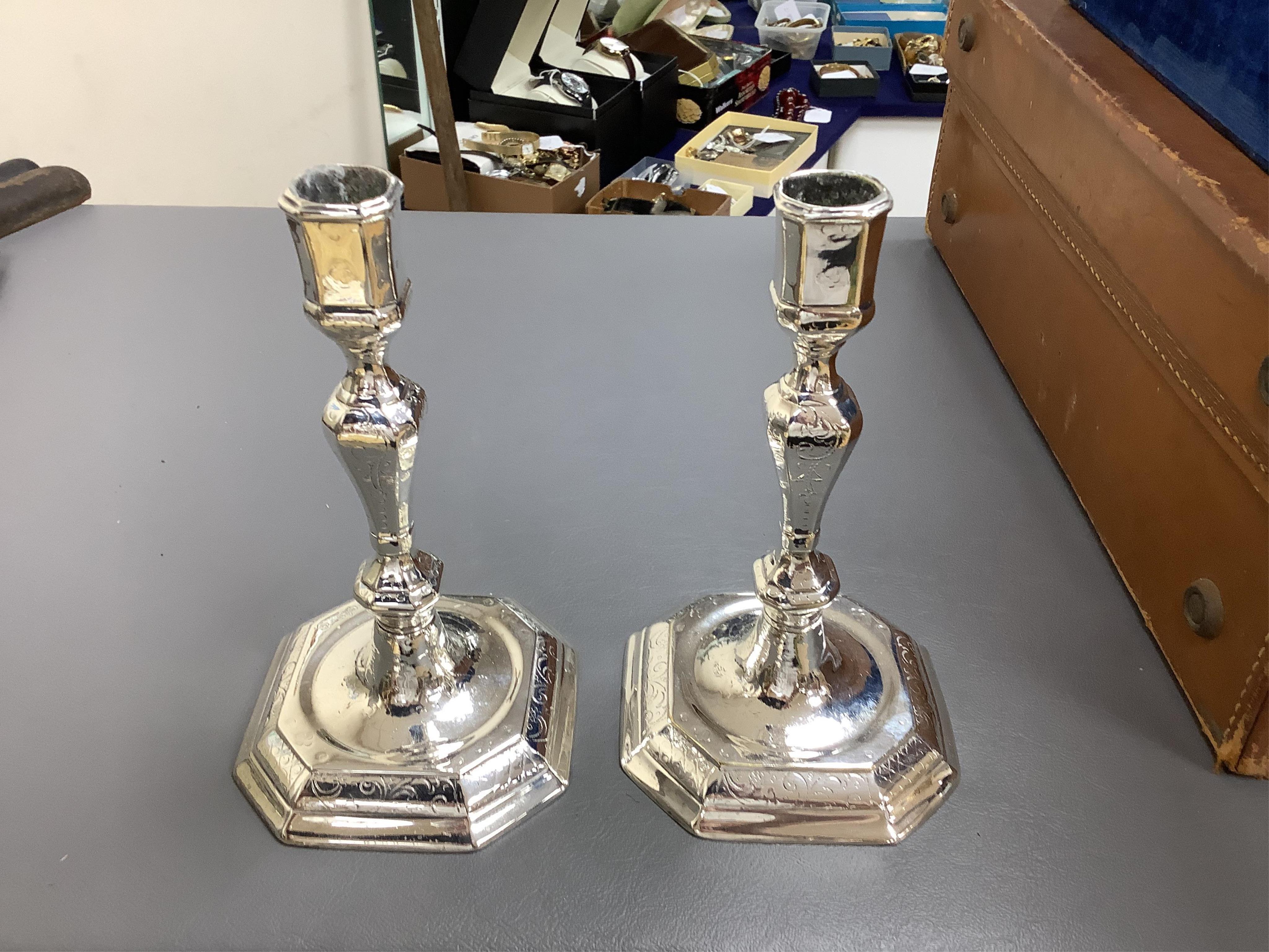 A pair of white metal candlesticks, a silver plated teapot circular tureen and cover spoons and forks and four spirit labels and large tray. Tray 73cm wide